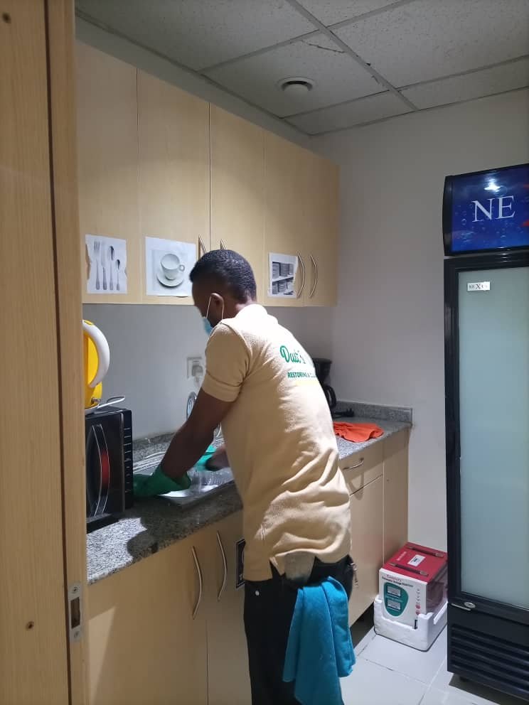 Dust and Wipes staff cleaning a commercial kitchen and breakroom