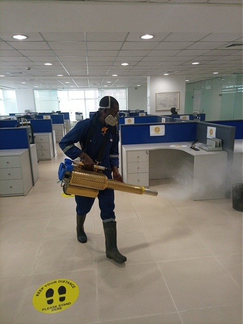 Dust and Wipes staff carrying out fumigation in a commercial office space in Abuja